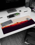 Artistic 36x16 inches mouse pad featuring fiery sunset over forest, inspiring creativity and adventure with bold colors.