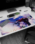 Silver-haired anime swordswoman in red-black coat on desk pad 40x20 inches, blade gleaming mid-action.