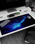 Desk pad showing a glowing cosmic portal core in an inky nebula swirl, 40x20 inches.
