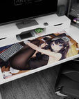 Playful bunny-suit anime girl stretching on wooden floor desk pad 40x20 inches, violet eyes and tights.