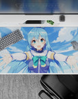 Anime desk pad 40x20 inches featuring Aqua from KonoSuba, with her arms wide open under a bright blue sky.