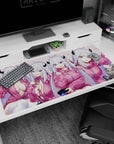 Cute demon girl in pink hoodie with black horns and a cheeky cat on an anime desk pad 40x20 inches.