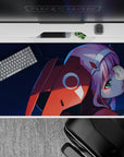 Intense 40x20 desk pad with deep blues, fiery reds, and Zero Two’s piercing green eyes for bold anime presence