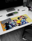Natsu flame punch front and center on Fairy Tail desk pad 36x16 inches, with Lucy and Erza posed behind.
