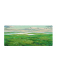 Mouse pad with rolling green hills, 28x12 inches, and shimmering waters for a peaceful, nature-filled workspace.