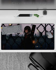 Moody-cute anime desk mat 32x16 inches in soft purples and slate blues with warm city streetlights.