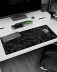 Artistic 36x16 inches desk pad featuring gridded topographic design, blending technical precision with organic contour lines on a black background.