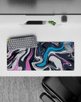 Abstract wave 28x12 mouse pad featuring dynamic swirls in pink, blue, and charcoal for a fluid, creative vibe in your workspace