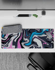 Abstract wave 32x12 mouse pad with bold swirls of pink, blue, and charcoal, adding vibrant energy and creativity to your desk