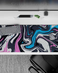 Creative 36x16 desk pad featuring bold swirls of pink, blue, and charcoal for an artistic, fluid design that enhances your workspace