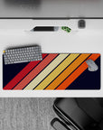 32x12 inches mouse pad with a retro diagonal stripe design, blending warm tones of orange, red, and yellow on a navy background for a bold look.