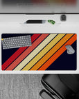 32x16 inches mouse pad with a retro diagonal stripe design, blending orange, red, and yellow tones against a navy background for a striking look.