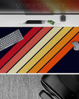 40x20 inches mouse pad showcasing a retro diagonal stripe pattern with orange, red, and yellow hues on a navy background for a vintage vibe.