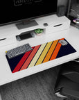 Artistic 32x12 inches mouse pad with diagonal stripes in orange, red, and yellow, set against a navy background for a classic, retro-inspired design.