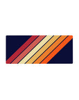 Mouse pad featuring a bold diagonal stripe pattern, 28x12 inches, with warm orange, red, and yellow tones on a navy background.