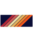 Compact 32x12 inches mouse pad with a bold diagonal stripe pattern, featuring warm orange, red, and yellow against a navy background.
