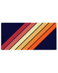 Mouse pad featuring a bold diagonal stripe pattern, 32x16 inches, with warm tones of orange, red, and yellow on a navy background for vintage flair.