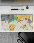 32x16 inches kawaii desk mouse pad in warm orange-to-pink hair tones, golden eyes, cozy mischievous vibe.