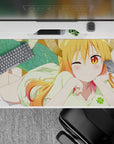 40x20 inches desk pad in warm orange-to-pink hair tones, golden eyes, cozy playful anime vibe.