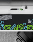 Striking 36x16 desk pad highlights vibrant green and light blue tones with intricate bubble details in stunning contrast