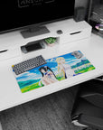 28x12 inches DanMachi mouse pad featuring Hestia and Ais under big cotton clouds in a sunny field.