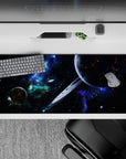 Midnight-cosmos desk pad 36x16 inches in deep black, neon blue, and smoky green tones.