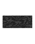 Mouse pad featuring black-on-black camouflage, 28x12 inches, with textured charcoal and graphite patterns for a sleek, bold desk design.