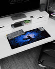 Berserk mouse pad, 28x12 inches, showcasing Guts in his Berserker Armor with jagged shadows and glowing blue light, ideal for creating a powerful atmosphere in your workspace.
