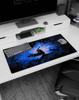 Modern 32x16 inches mouse pad showcasing Guts in his Berserker Armor with glowing blue light and jagged shadows, ideal for fans seeking powerful, visually striking designs.