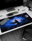 Large 40x20 inches desk pad with Guts in his Berserker Armor, surrounded by jagged shadows and a glowing blue light, perfect for adding intense battle energy to your desk.