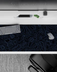 Striking 36x16 desk pad highlights intricate blue lines with deep black contrast for a refined sense of motion and depth