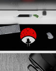 Anime desk pad featuring Itachi Uchiha from Naruto against red Uchiha crest, 36x16 inches, evokes loyalty and legacy.