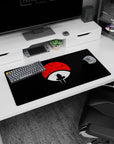 Anime mouse pad 32x16 inches featuring Itachi Uchiha against a red Uchiha crest, perfect for Naruto fans.