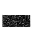 Mouse pad featuring black and white topographic design, 28x12 inches, with sharp lines and dotted patterns for a bold, modern workspace aesthetic.