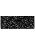 Compact 32x12 inches mouse pad with black and white topographic design, blending bold lines and dotted patterns for a sleek and graphic touch.