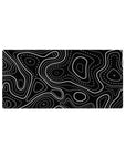 Mouse pad featuring black and white topographic design, 32x16 inches, with sharp lines and dotted patterns for a bold, structured aesthetic.