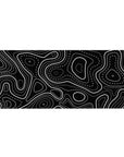 Desk pad featuring black and white topographic design, 36x16 inches, with sharp lines and dotted patterns, adding depth and structure to your desk.