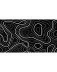 Desk pad featuring black and white topographic design, 40x20 inches, with sharp lines and dotted patterns for a sleek, structured aesthetic.