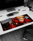 36x16 inches anime desk pad featuring a spiky blond shooter in a crimson coat aiming a pistol forward.