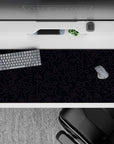 Striking 36x16 desk pad highlights intricate dark purple lines with deep black contrast for a sense of depth and motion
