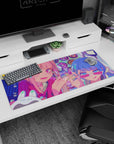 36x16 inches anime desk pad showing winking pink-haired girl and blue-haired friend in sharp sunglasses.
