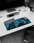 Cosmic-themed 28x12 inches mouse pad featuring blue and black waves with pixelated dinosaurs, bringing personality to your workspace.