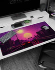 Large 40x20 inches desk pad featuring Sunset Drive Rush, blending retro-futuristic cars and a vibrant pink sunset over a neon-lit city highway.