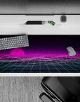 36x16 inches desk pad with a glowing pink sunset and retro-futuristic gridlines, capturing the essence of vaporwave aesthetics.