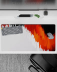 Impactful 32x16 desk mat combines blazing orange and white hues with fluid abstract patterns for visually striking visuals