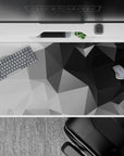 40x20 inches desk pad with geometric grayscale design, blending sharp angles and shades of black, gray, and white for a modern, understated look.