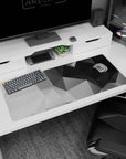 Artistic 36x16 inches desk pad featuring geometric grayscale design, with sharp angles and varying shades of black, gray, and white for modern style.