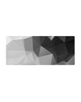 Mouse pad featuring geometric grayscale design, 28x12 inches, with sharp angles and a blend of black, gray, and white for a sleek workspace.