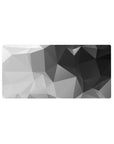 Mouse pad featuring geometric grayscale design, 32x16 inches, with sharp angles and a blend of black, gray, and white for a sleek minimalist effect.