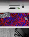 Vibrant 36x16 desk pad featuring swirling purple and red tones for an abstract design that brings energy and movement to your workspace